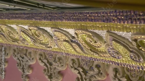 Pillars with floral patterns of Erawan Museum, support the stained glass ceiling. The pillars are adorned with intricate designs and religious imagery, contributing to the museum's overall aesthetics