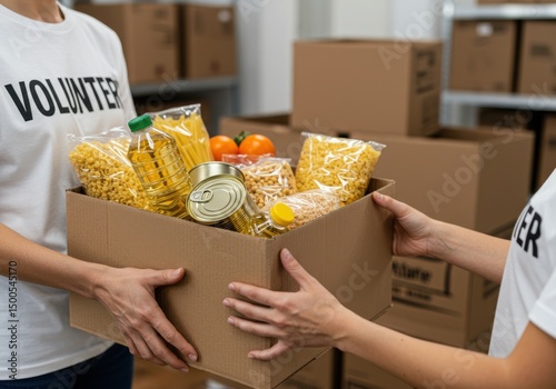 Volunteer hands holding a box filled with food items for donation drive event