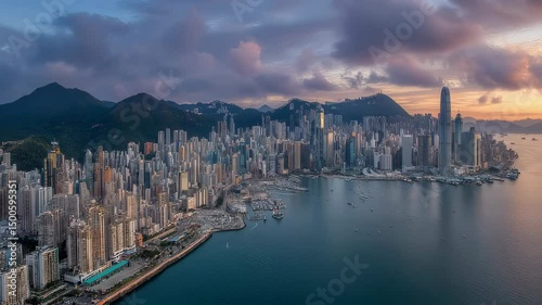 Hong kong skyline with towering skyscrapers and victoria harbour waterfront under dramatic sunset light