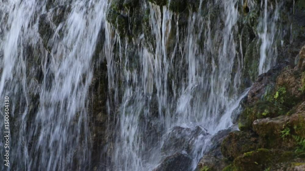 Waterfall over Rocks. Waterfall cascades over the rocks. A close-up fragment of a mountain waterfall, camera movement. Waterfall over Rocks. Waterfall cascades over the rocks. A close-up fragment of a mountain waterfall, camera movement.