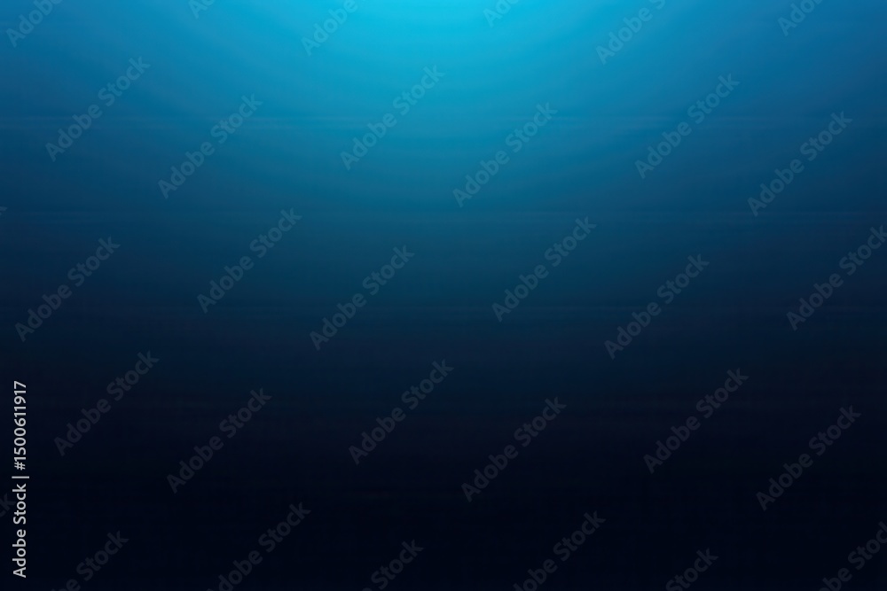 Obraz premium A deep blue gradient fades from light at the top to dark at the bottom, resembling an underwater or oceanic scene.