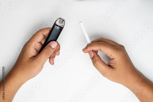 Human hand holding a cigarette, rolled tobacco in paper with a filter tube, and a vape or electronic cigarette are isolated on a white background. No or quit smoking, a bad habit, and unhealthy