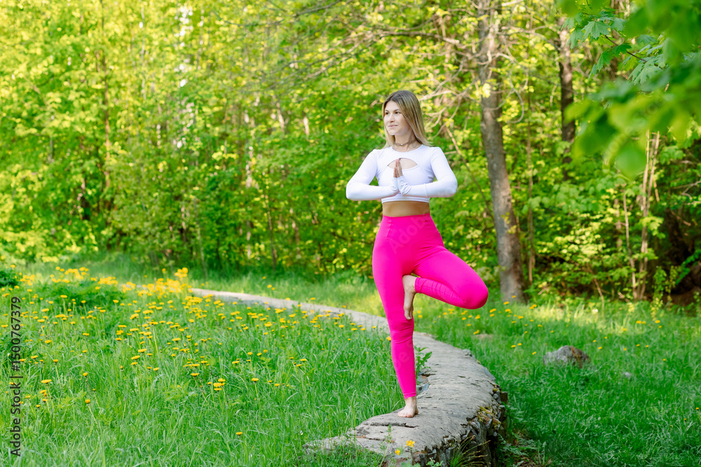 Young girl in the park doing yoga. Young woman in the green park. Yoga poses Young girl in the park doing yoga. Young woman in the green park. Yoga poses