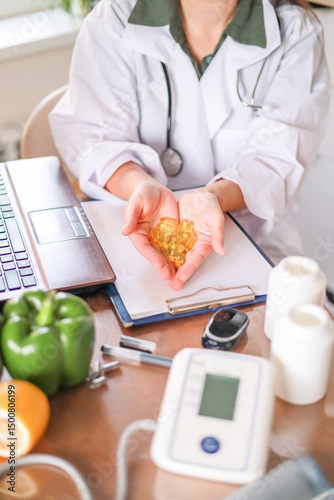 Close-up of doctor holding handful of clear yellow oval capsules in palms. dietary supplements, vitamin d, omega 3, fish oil.