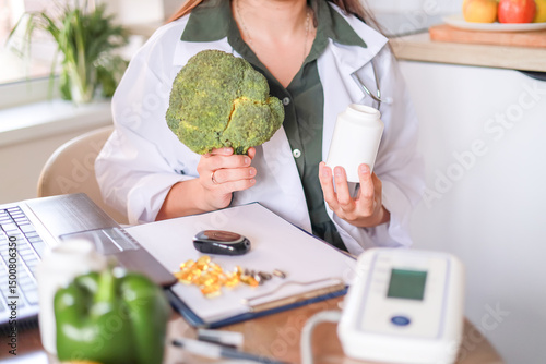 Doctor shows broccoli and white jar with supplements for health maintenance and weight control. Medical consultation and wellness concept. Mockup, template