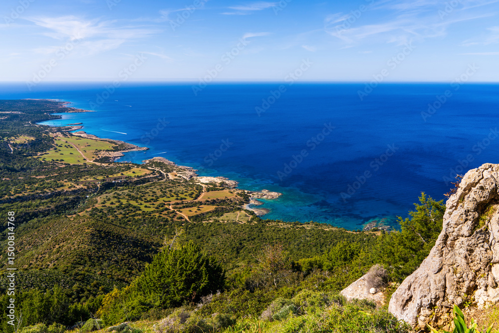 Stunning aerial panoramic view of rugged and rocky coastline of Cyprus with turquoise waters and steep sea cliffs. Summer Mediterranean seascape, wild nature and natural landscape. Stunning aerial panoramic view of rugged and rocky coastline of Cyprus with turquoise waters and steep sea cliffs. Summer Mediterranean seascape, wild nature and natural landscape.