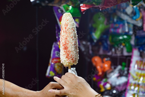 Boiled corn with cheese and spicy, typical Mexican street food. Food stall. Elote