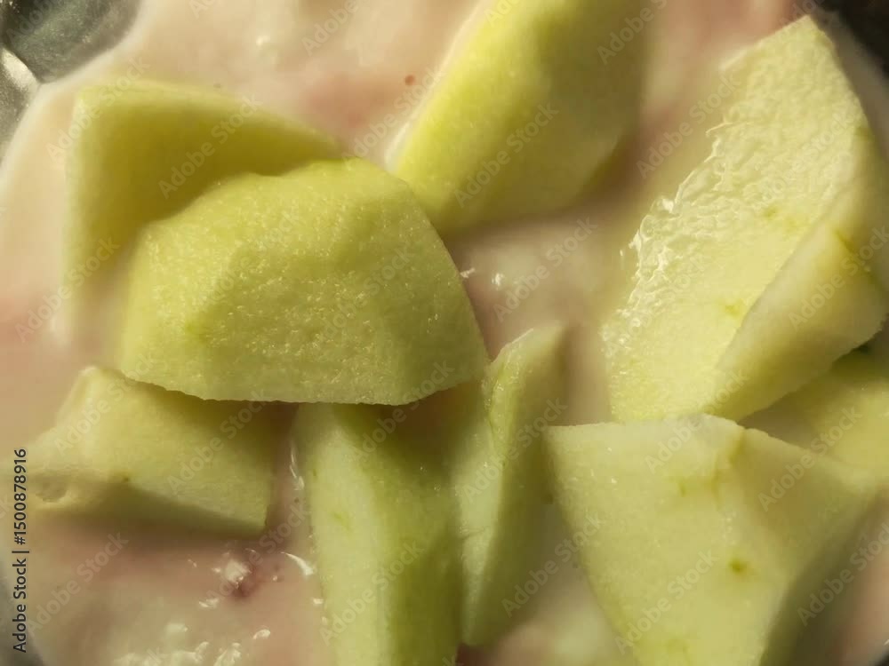 Chunks of green apple in creamy yogurt with a hint of pink fruit mixed in. Chunks of green apple in creamy yogurt with a hint of pink fruit mixed in.