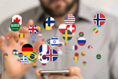 Wallpaper Mural A man interacts with a phone displaying flags of various countries, symbolizing global communication. Torontodigital.ca