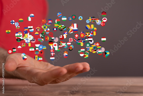Wallpaper Mural Image of many national flags floating above an open hand, symbolizing global unity and connection. Torontodigital.ca