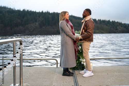 Canvas-taulu Smiling man proposing marriage to woman on bridge
