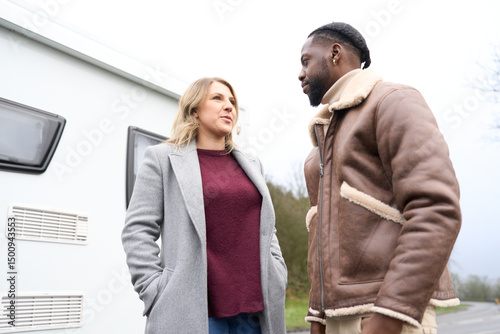 Couple talking near motorhome photo