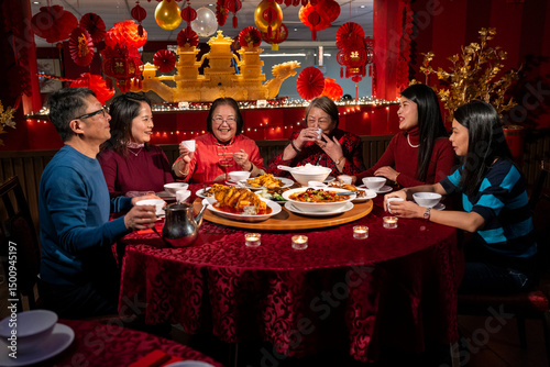 Smiling family enjoying Chinese New Year dinner in restaurant