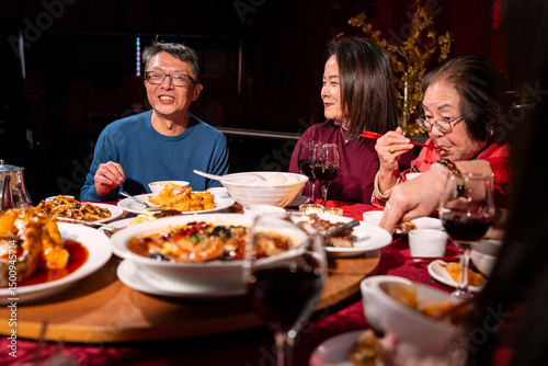 Family enjoying Chinese New Year dinner in restaurant