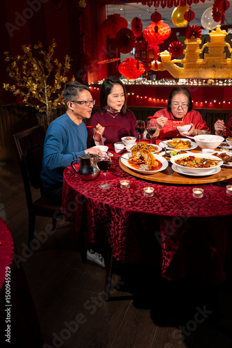 Family enjoying Chinese New Year dinner in restaurant