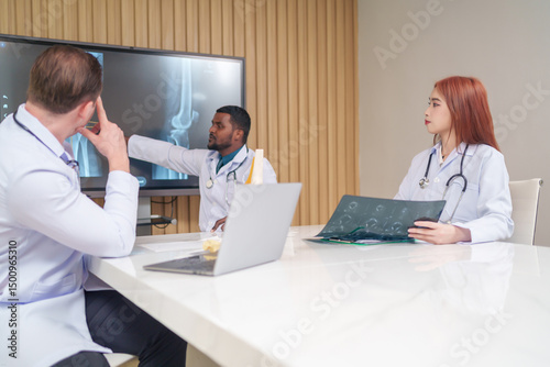medical team discussing and review rare disease case to improve the practice guidelines,multiracial orthopedic doctors working in medical conference room