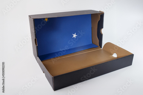 an open cardboard box with a striking blue interior. Inside, two stars stand out. recycling idea, simple material for DIY project and creative craft for kids. how to make diorama for Christmas,
