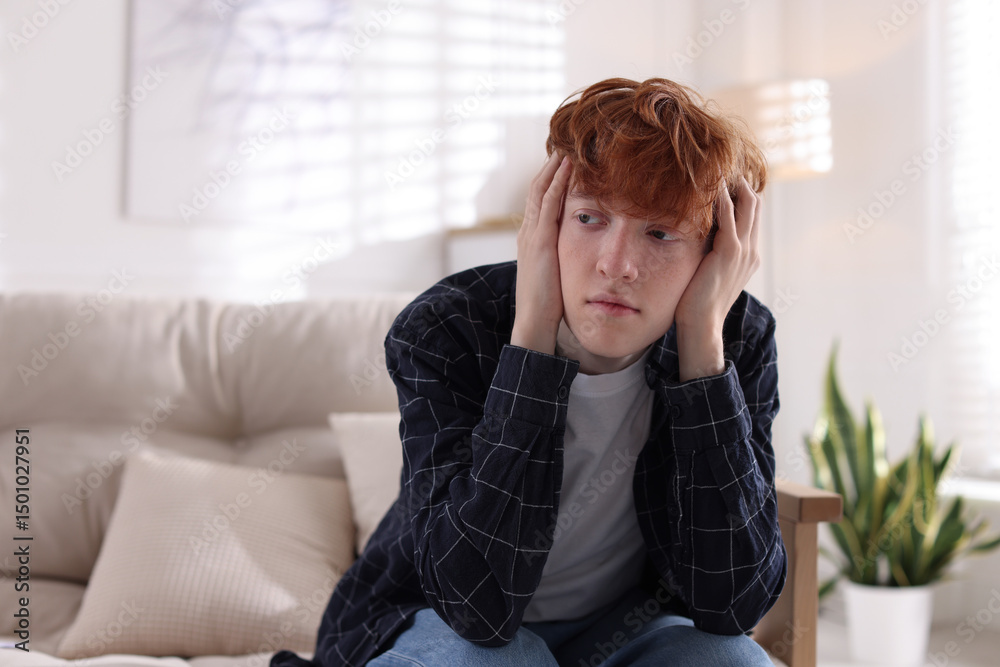 Teen problems. Depressed teenage boy on sofa at home, space for text Teen problems. Depressed teenage boy on sofa at home, space for text
