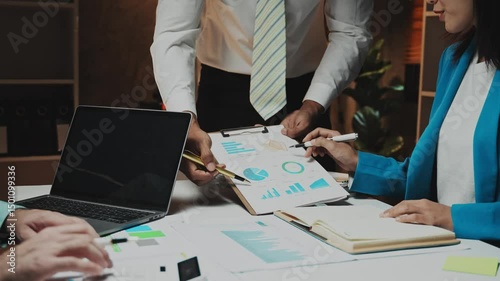 Business people meeting overtime, brainstorming, discussing, analyzing and planning business strategies..Concept of teamwork and overtime