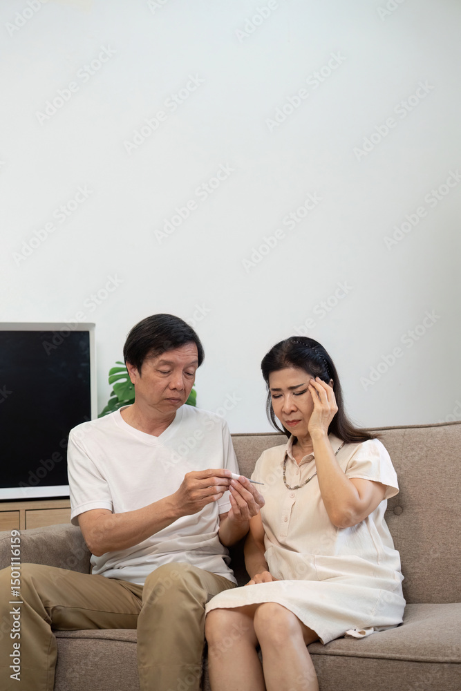 Wellness and Care. Elderly couple discussing health while sitting on a sofa. Wellness and Care. Elderly couple discussing health while sitting on a sofa.