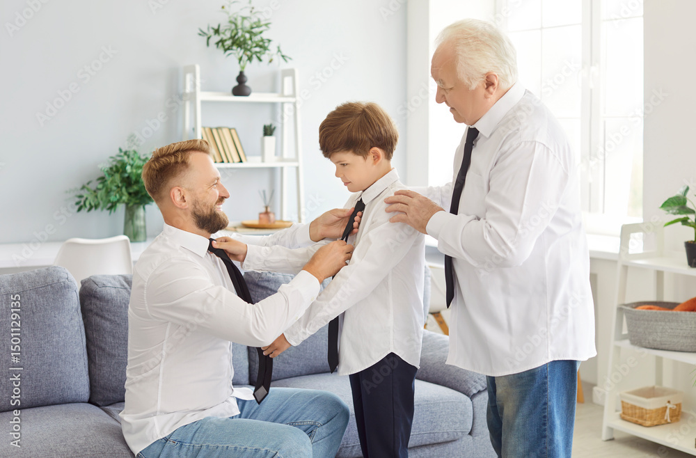 Obraz premium Cheerful multi generation male family wearing white shirts dressing, fixing outfits and preparing for special occasion. Smiling father and grandfather helping young boy, teaching him to tie necktie.