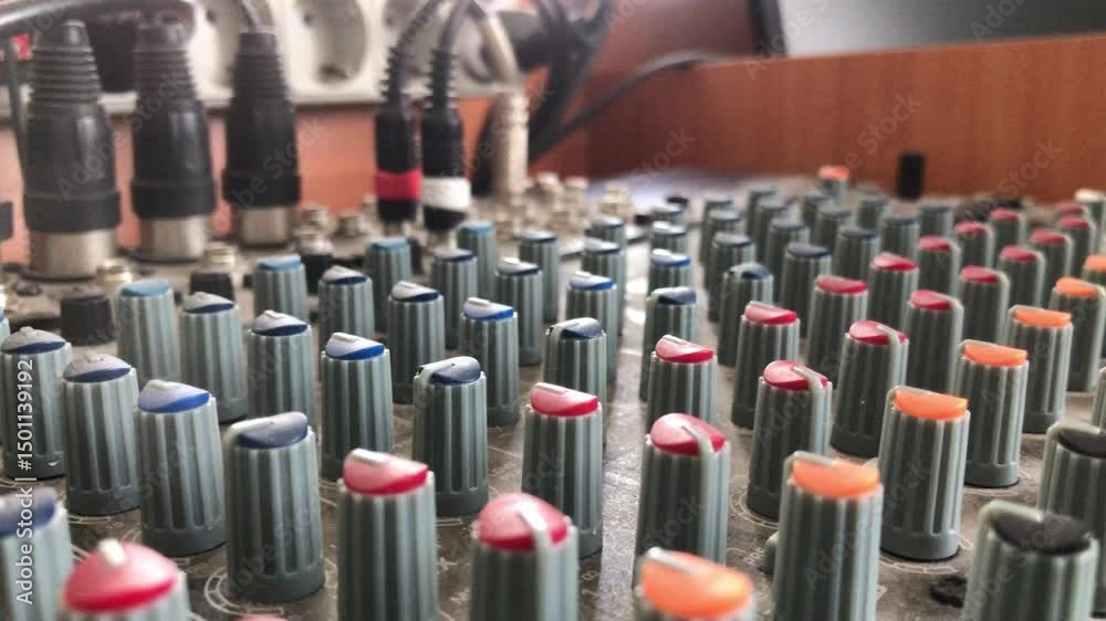 Exploring the controls of an audio mixing console in a studio