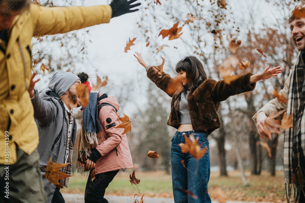 Fototapeta premium A joyful group of friends enjoying an autumn day outdoors by playing in falling leaves. The image conveys happiness, friendship, and the beauty of nature during the fall season.