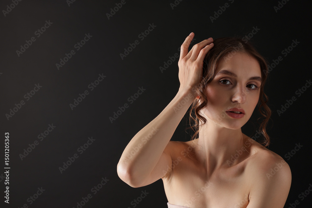 Fototapeta premium Portrait of gorgeous young woman on black background. Space for text