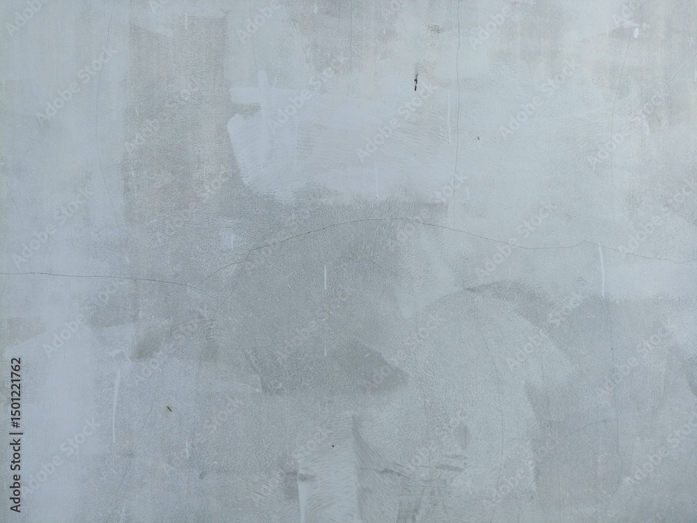 Naklejka premium Light Gray Concrete Wall Texture with Natural Cracks and Brush Patterns. Light gray concrete wall with visible cracks and brush marks, perfect for backgrounds, textures, or industrial-themed design