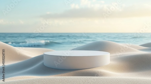 White cylinder platform sits softly atop gentle sand dunes near a tranquil ocean vista