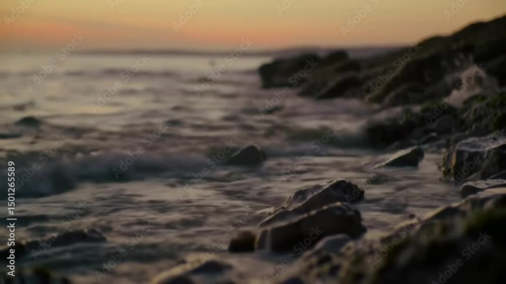 Coastal Twilight: Waves Crashing Against Rocky Shoreline At Sunset Coastal Twilight: Waves Crashing Against Rocky Shoreline At Sunset