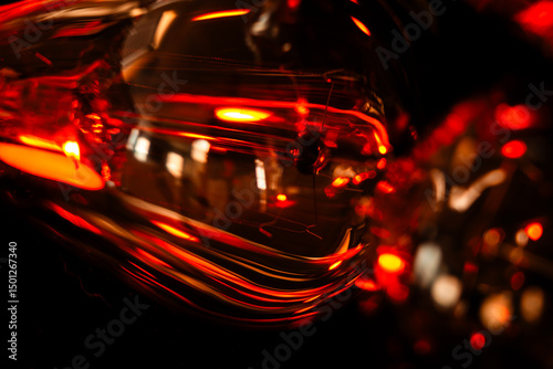 Macro image of filaments inside edison bulb in warm light