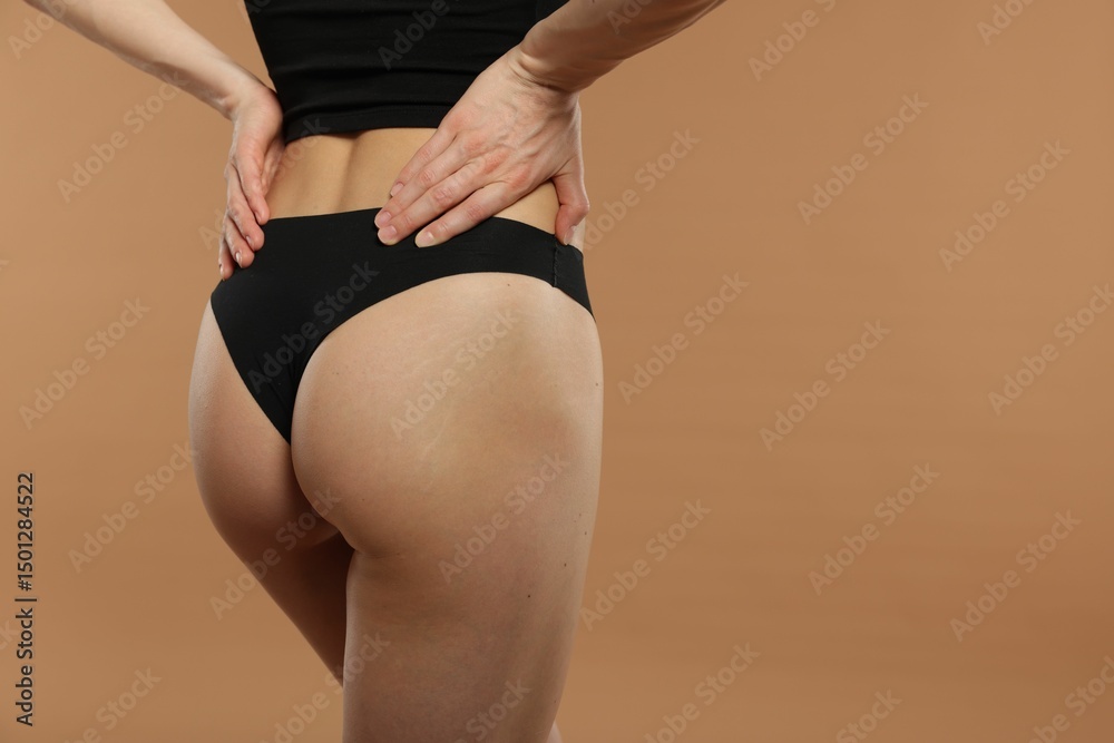Fototapeta premium Woman with perfect slim body on beige background, closeup. Space for text