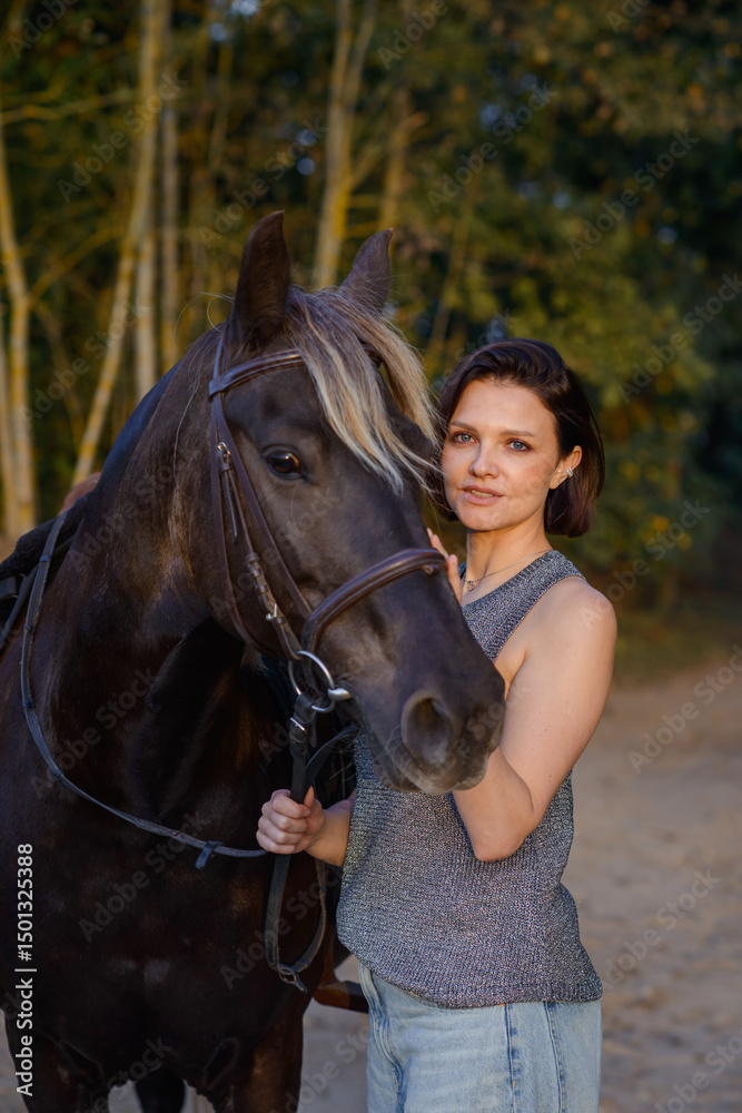 Obraz premium beautiful girl with horse walking in park in summer. equestrian sport