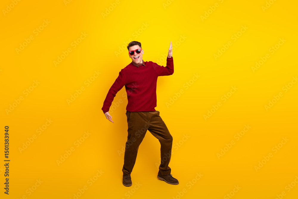 Fototapeta premium Cheerful Young Man Posing in Stylish Attire Against Vibrant Yellow Background