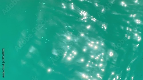 Open water surface of the sea with small waves. Natural background with sun sparkles on the surface of the water. Meditation, relaxation, peace, tranquility