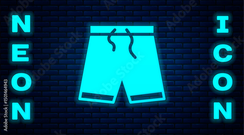 Glowing neon Swimming trunks icon isolated on brick wall background. Vector