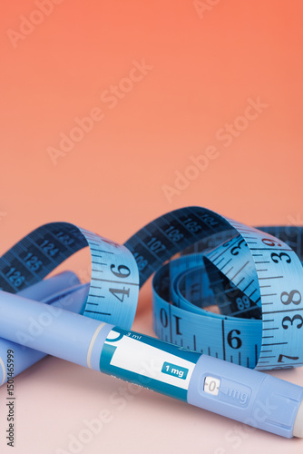 Anti-obesity medical treatment shown with semaglutide pens and measuring tape