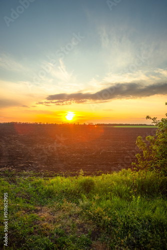 Golden Sunset Over Freshly Plowed Farmland