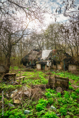 Abandoned Rural Property with a Collapsed House and Ground Littered with Plastic Bottles