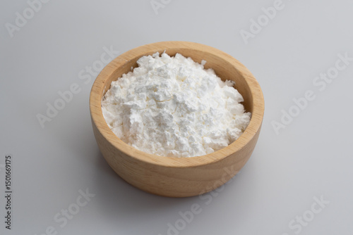 Close-up of tapioca starch or flour powder in spoon with white background