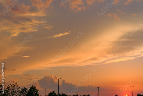 Vast Orange Sunset Sky with Silhouetted Streetlights