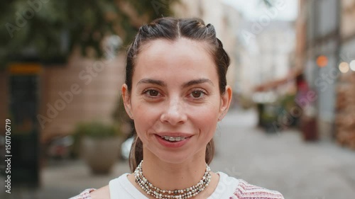 Portrait of happy young woman face with teeth braces smiling friendly open eyes glad expression looking dreaming resting relaxation feel satisfied good news outdoors. Pretty adult girl on city street