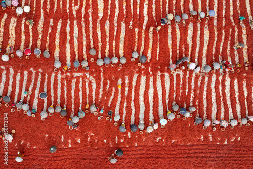 Aerial view of vibrant agricultural fields with sun-dried red chillies and intricate patterns, Durgahata, Rajshahi, Bangladesh.