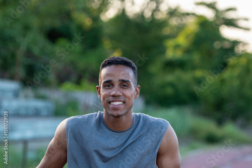 Portrait of smiling young man relaxing after training outdoors