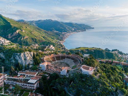 Aerial drone view of Teatro Antico di Taormina during sunrise, Island of Sicily, italy photo