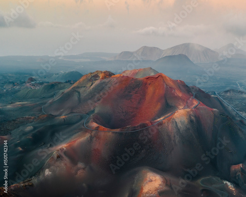 Aerial view of dramatic volcanic landscape with rugged mountains and colorful crater, Timanfaya National Park, Canary Islands, Spain. photo