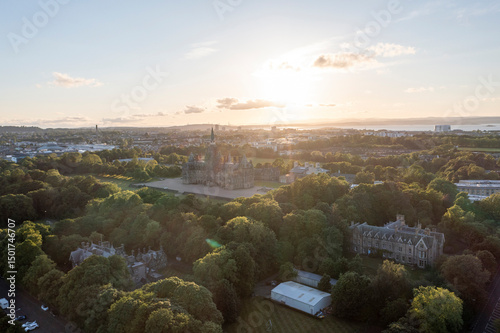 Aerial view of Fettes Public School amidst beautiful trees and a picturesque cityscape at sunset, Comely Bank, Midlothian, Scotland. photo