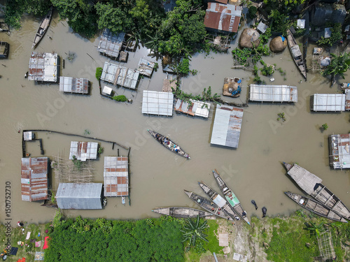 Aerial view of flooded homes and boats in a devastated community, Chilmari, Bangladesh. photo