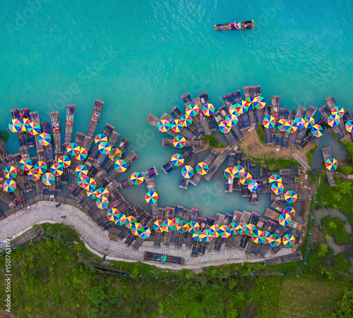 Aerial view of traditional wooden floating raft with colourful umbrellas along the Lijiang River in Guilin, Guangxi, China. photo
